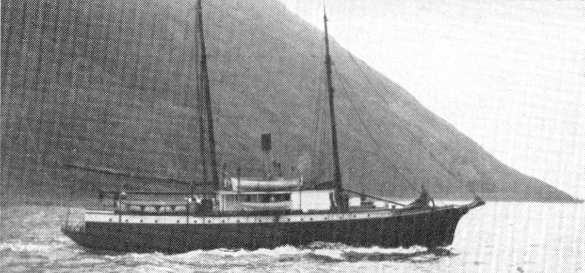 A two-mast ship sailing in front of an Alaskan fjord
